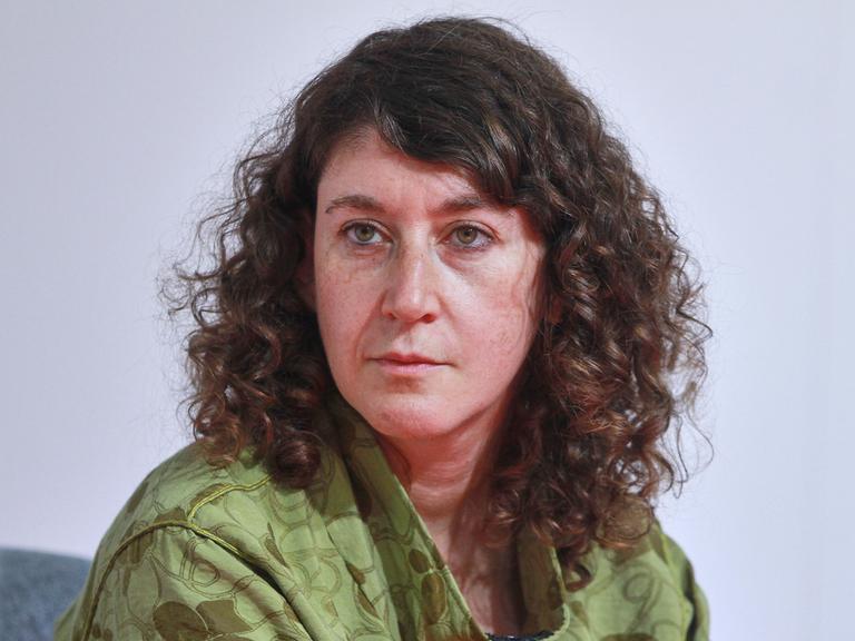 Lena Gorelik trägt eine grüne Jacke und schaut zur Seite.