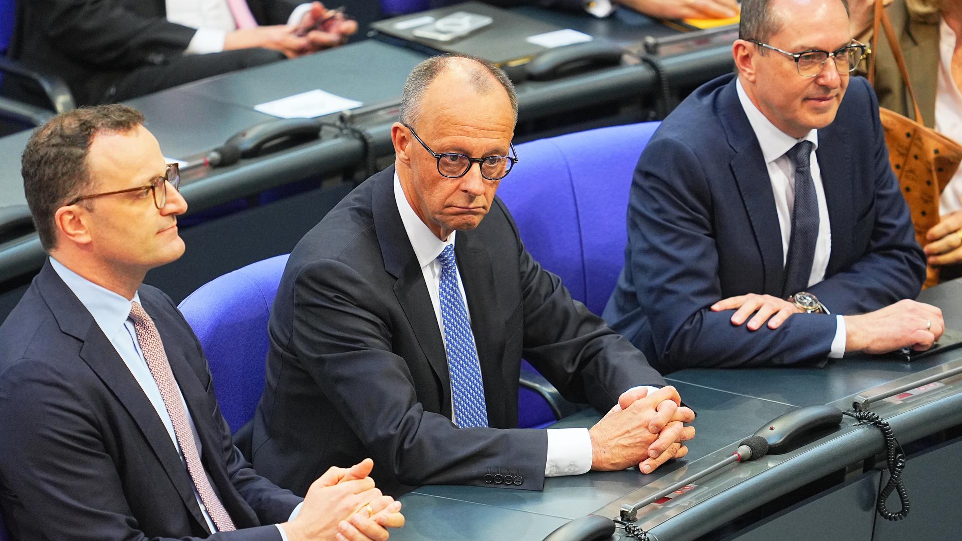 Friedrich Merz (CDU, M), sitzt zwischen Alexander Dobrindt (CSU, r), und Jens Spahn (CDU), Vorsitzender der CDU/CSU Bundestagsfraktion, im Bundestag bei der Kanzlerwahl.